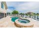 Backyard pool and jacuzzi with a water view and travertine tile at 3545 Seaway Dr, New Port Richey, FL 34652