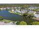 Aerial view showing a waterfront community with homes nestled among serene lakes and lush greenery at 3553 Delta Pl, Holiday, FL 34691