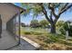 Scenic backyard view from the screened porch, showcasing lush greenery and a tranquil waterfront setting at 3553 Delta Pl, Holiday, FL 34691