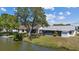 Peaceful backyard featuring a screened-in porch and a tranquil waterfront view at 3553 Delta Pl, Holiday, FL 34691