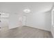 Large bedroom with plank flooring leads to an ensuite and walk in closet at 3553 Delta Pl, Holiday, FL 34691