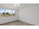 Bright bedroom with large window and plank flooring overlooking manicured landscaping at 3553 Delta Pl, Holiday, FL 34691