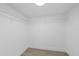 Walk in closet with wire shelving and plank flooring at 3553 Delta Pl, Holiday, FL 34691