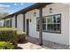 Charming front porch with decorative columns, stylish hanging lanterns, and lush landscaping at 3553 Delta Pl, Holiday, FL 34691