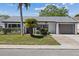 Charming one-story home featuring a well-manicured lawn, decorative palms, and inviting curb appeal at 3553 Delta Pl, Holiday, FL 34691