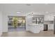Modern kitchen with stainless steel appliances, white cabinetry, and a scenic water view at 3553 Delta Pl, Holiday, FL 34691