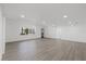 Bright living room with luxury vinyl flooring, modern door, and a large window at 3553 Delta Pl, Holiday, FL 34691