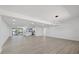 Bright and open living space with sleek hardwood floors and modern lighting fixtures at 3553 Delta Pl, Holiday, FL 34691
