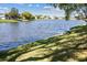 Scenic view of the community pond featuring a bench and a pair of ducks taking flight at 3553 Delta Pl, Holiday, FL 34691