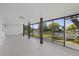 Large screened lanai with views of the backyard, water, and durable flooring great for entertaining at 3553 Delta Pl, Holiday, FL 34691