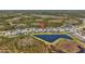 Aerial view of the community showcasing the neighborhood layout, water features, and surrounding nature at 3966 Tour Trce, Land O Lakes, FL 34638