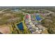 Wide aerial view of the community showcasing the neighborhood layout, water features, and surrounding nature at 3966 Tour Trce, Land O Lakes, FL 34638
