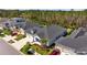 Aerial view of the home showcasing the well-manicured lawn, driveway, and surrounding neighborhood at 3966 Tour Trce, Land O Lakes, FL 34638