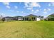 Lush backyard featuring a well-maintained lawn, a covered patio, and tasteful landscaping, creating a serene outdoor space at 3966 Tour Trce, Land O Lakes, FL 34638