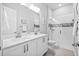 Bathroom with dual sinks, quartz countertops, and glass enclosed shower at 3966 Tour Trce, Land O Lakes, FL 34638