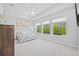 Bedroom with three large windows, tray ceiling, ceiling fan, and neutral decor providing ample natural light and a spacious feel at 3966 Tour Trce, Land O Lakes, FL 34638