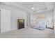 Bedroom with three large windows, tray ceiling, ceiling fan, and neutral decor providing ample natural light and a spacious feel at 3966 Tour Trce, Land O Lakes, FL 34638
