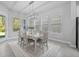 Well-lit dining room featuring modern chandelier, dining table set for six, and large windows at 3966 Tour Trce, Land O Lakes, FL 34638