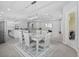 Bright dining area features a modern chandelier and flows into an open floor plan with a view of the living room and kitchen at 3966 Tour Trce, Land O Lakes, FL 34638