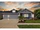 Charming single-Gathering home with a well-manicured lawn and a three-car garage at sunset at 3966 Tour Trce, Land O Lakes, FL 34638
