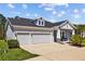Charming two-story home with gray exterior, three car garage, and covered front porch at 3966 Tour Trce, Land O Lakes, FL 34638