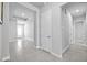 Open hallway with a view into other rooms, tiled flooring, and neutral paint creates a welcoming and airy atmosphere at 3966 Tour Trce, Land O Lakes, FL 34638