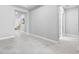 Hallway with ceramic tile flooring that leads to a bright living area, showcasing the home's seamless open floor plan at 3966 Tour Trce, Land O Lakes, FL 34638