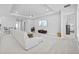 Spacious living room features a tray ceiling, recessed lighting, and a large, comfortable white sectional sofa at 3966 Tour Trce, Land O Lakes, FL 34638