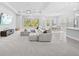 Expansive living space boasts large windows offering backyard views, complemented by a modern entertainment setup and plush carpeting at 3966 Tour Trce, Land O Lakes, FL 34638