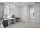Bright office space with large window, desk, and neutral gray carpet and walls at 3966 Tour Trce, Land O Lakes, FL 34638