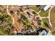 Aerial view of the community playground and fire pit area with green grass at 3966 Tour Trce, Land O Lakes, FL 34638