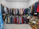 Large walk-in closet with ample hanging space and shoe storage on metal shelving units at 3966 Tour Trce, Land O Lakes, FL 34638