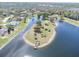 Aerial view of a beautiful lake, and park like space, with a dock for launching kayaks at 4404 Lake In The Woods Dr, Spring Hill, FL 34607