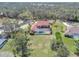 Aerial view showcasing the home's screened-in pool, lush greenery, and proximity to natural surroundings at 4404 Lake In The Woods Dr, Spring Hill, FL 34607