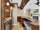 Entertainer's dream basement bar featuring custom cabinets, sink, and stone fireplace at 4404 Lake In The Woods Dr, Spring Hill, FL 34607