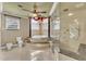 Elegant bathroom boasts a jacuzzi tub with decorative columns and a frameless glass shower at 4404 Lake In The Woods Dr, Spring Hill, FL 34607
