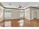 Bright, airy bedroom showcases wood floors, two arched windows, and a decorative ceiling at 4404 Lake In The Woods Dr, Spring Hill, FL 34607