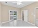 Bright bedroom with tile flooring and access to a screened-in lanai with a view of the backyard pool at 4404 Lake In The Woods Dr, Spring Hill, FL 34607