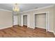 Spacious bedroom with wood flooring, closet storage, and chandelier lighting at 4404 Lake In The Woods Dr, Spring Hill, FL 34607