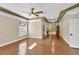 Spacious bedroom featuring hardwood floors, large windows, ceiling fan and decorative tray ceiling at 4404 Lake In The Woods Dr, Spring Hill, FL 34607