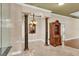 Elegant entryway with decorative columns, marble floors, a chandelier, and a wooden display case at 4404 Lake In The Woods Dr, Spring Hill, FL 34607