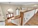 Grand entryway featuring wood staircase, herringbone floors, and a decorative chandelier at 4404 Lake In The Woods Dr, Spring Hill, FL 34607