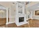 A decorative white fireplace with mirror and elegant chandeliers provides a stunning focal point in the foyer at 4404 Lake In The Woods Dr, Spring Hill, FL 34607