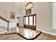 Grand foyer with hardwood floors, a stunning chandelier, and elegant staircase leading to the upper level at 4404 Lake In The Woods Dr, Spring Hill, FL 34607