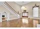 Inviting foyer with high ceilings, wood floors, an elegant staircase, and a view of the front door at 4404 Lake In The Woods Dr, Spring Hill, FL 34607