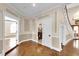 Stately foyer boasts decorative trim and inlaid wood floors, leading to an elegant staircase at 4404 Lake In The Woods Dr, Spring Hill, FL 34607