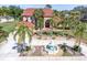 Stunning two-story home with a circular driveway, fountain and lush landscaping at 4404 Lake In The Woods Dr, Spring Hill, FL 34607