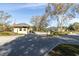 A gated community entrance with guard house and flag at 4404 Lake In The Woods Dr, Spring Hill, FL 34607