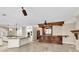 Open-concept kitchen with granite counters, an island, and a wet bar for entertaining at 4404 Lake In The Woods Dr, Spring Hill, FL 34607