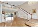 Spacious living room featuring high ceilings, hardwood floors, and a staircase with elegant wood and white trim at 4404 Lake In The Woods Dr, Spring Hill, FL 34607